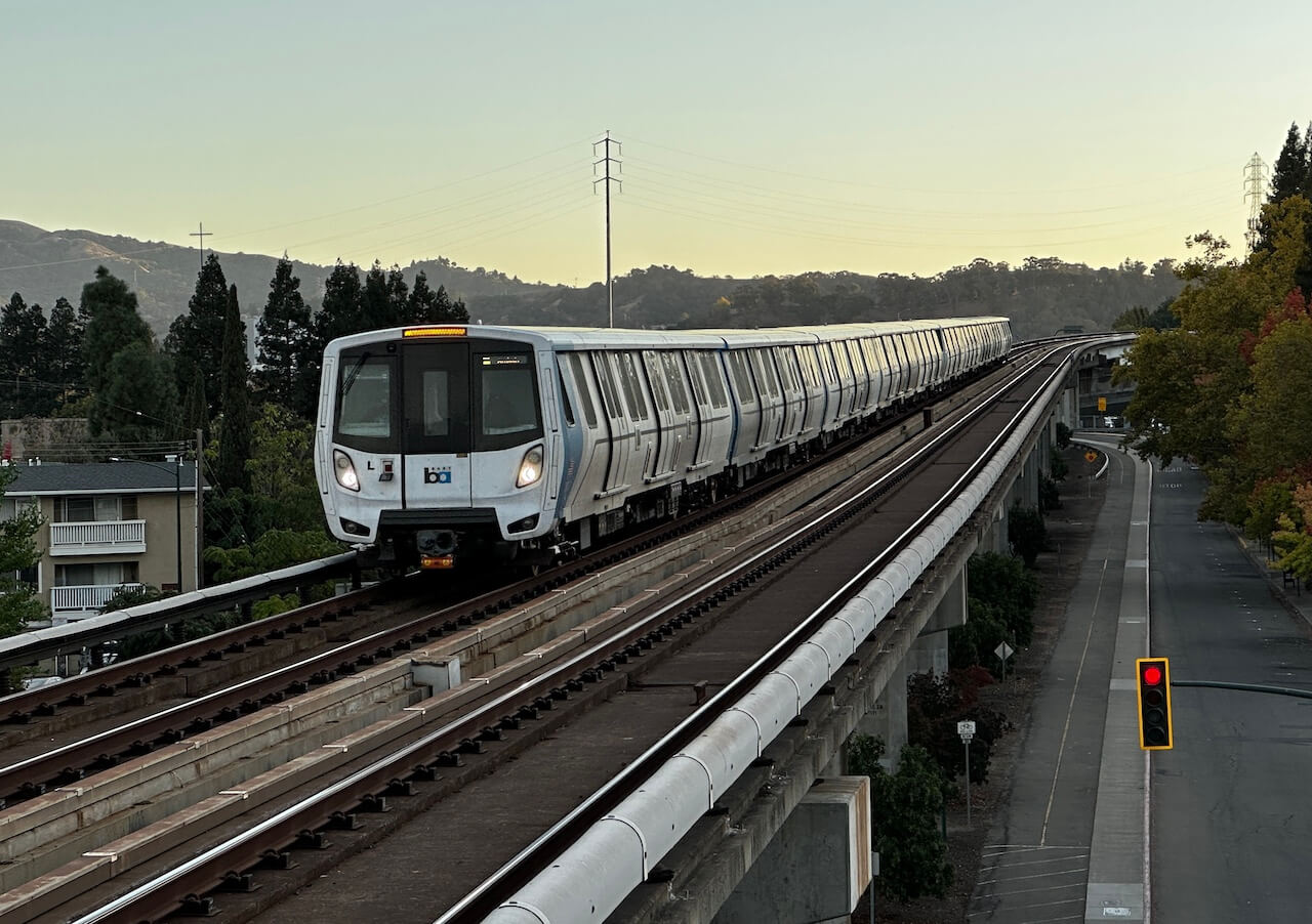 A BART train on a bridge approaching Walnut Creek station.